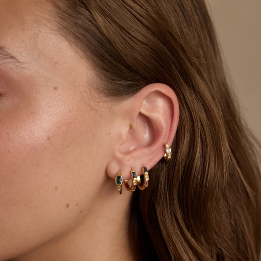 These textured huggies sparkle with a rich oval London Blue Topaz complimented by a marquise Cubic Zirconia accent.
Whether worn solo for a touch of understated elegance or mixed into your favourite stack, they are an invitation to express your creative spirit.