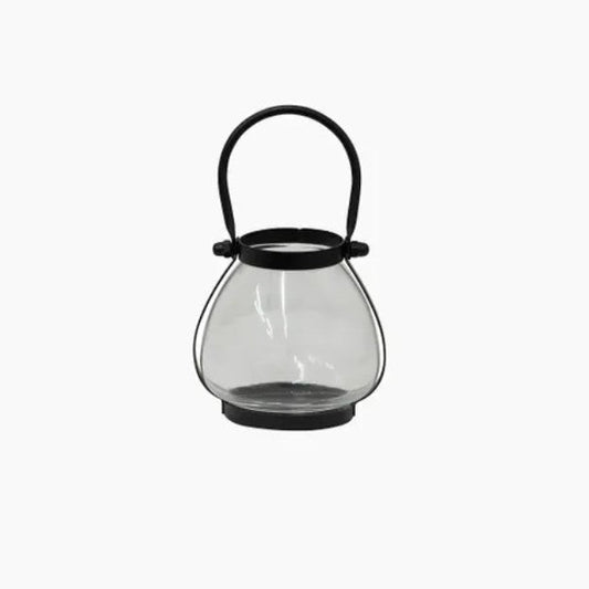 Clear glass lantern with black handle on a white background