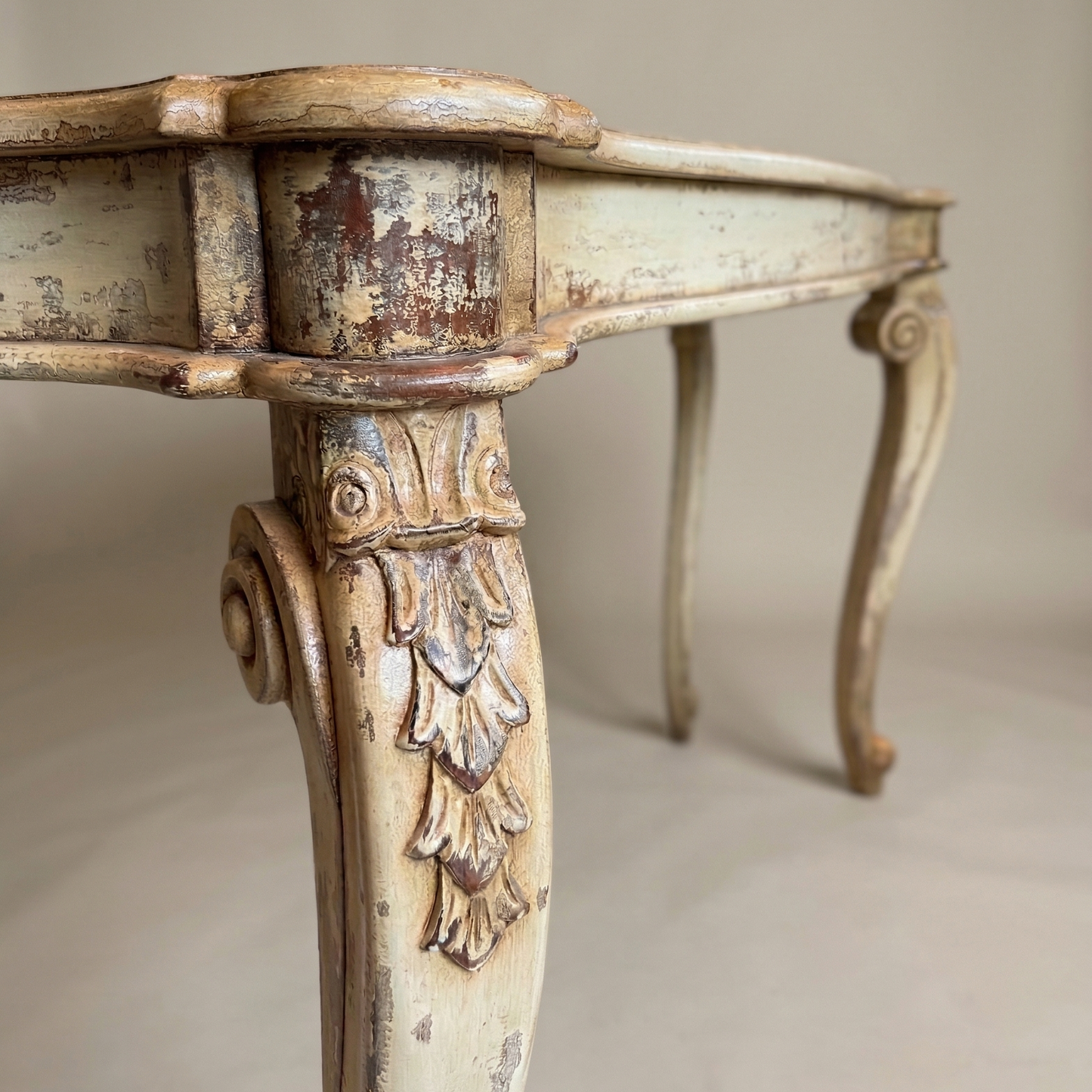 Vintage-style table with ornate legs on a neutral background