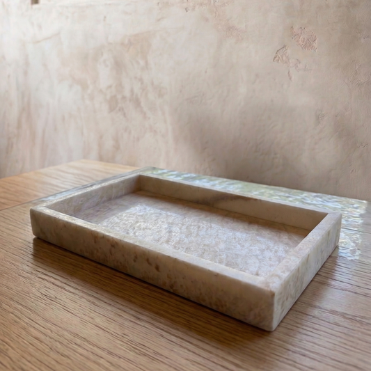 Rectangular onyx tray on a wooden surface with a neutral wall background