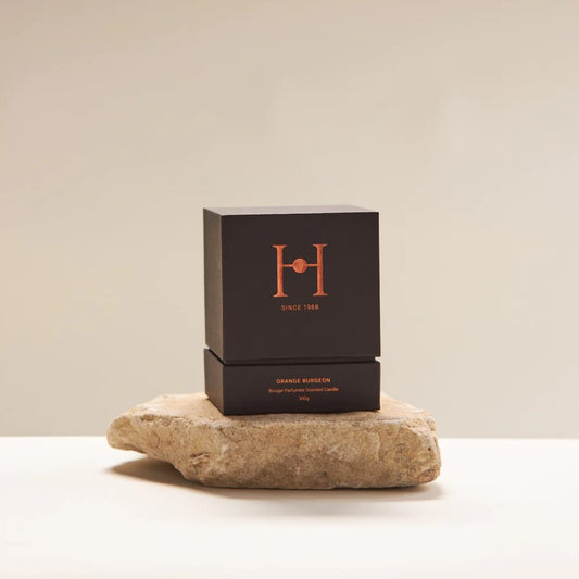 Experience the elegance of our Orange Burgeon candle, featuring soft citrus and herbaceous basil undertones, creating a fresh and uplifting ambience. When burning this candle top notes of lime zest and mandarin peel will fill your space along with heart notes of basil leaf and thyme and base notes of jasmine, cyclamen and amber. Combined, its unique scent is a mix of floral and citrus fragrances with warm undertones of basil with a peppery, minty edge. Boxed.