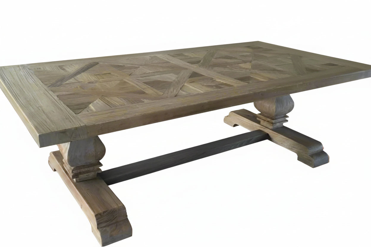 The Parco Coffee Table is expertly crafted from reclaimed elm and boasts a sophisticated parquetry pattern and traditional pedestal legs. Its timeless design and sturdy construction, coupled with its organic details, create a warm and welcoming addition to any living room. Front