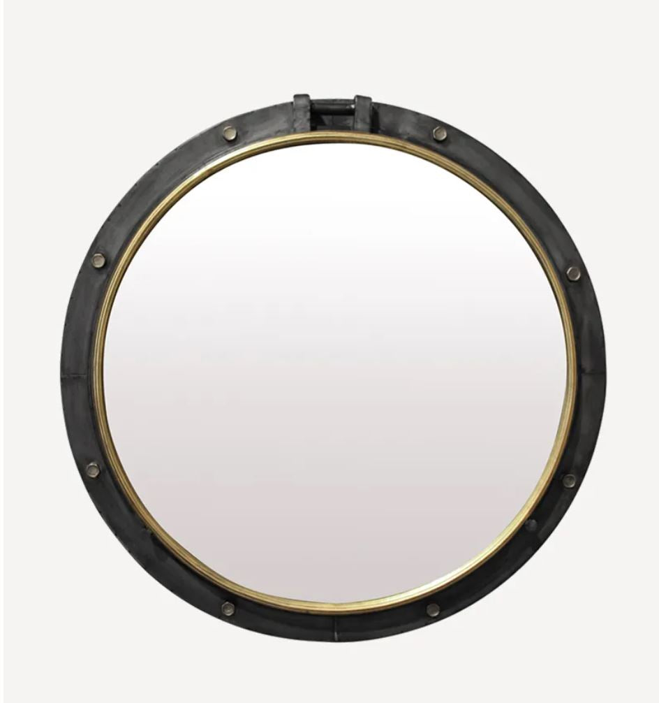 Round mirror with black frame and gold interior on a white background