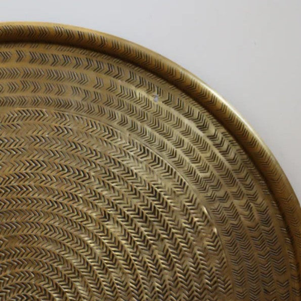 This handcrafted aluminium tray boasts an antique gold brass finish, making it an elegant addition to dining tables, coffee tables, ottomans, or console decor. Showcase the tray as a magnificent serving platter, or use it as a stylish base layer for decorative displays in the home. Corner