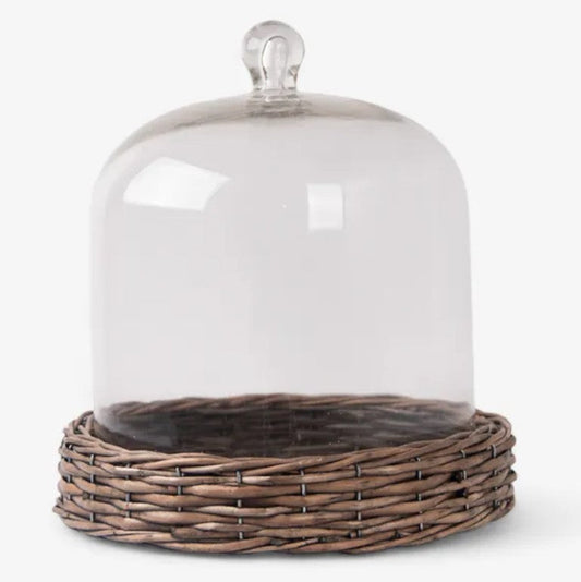 Glass cloche with wicker base on a white background