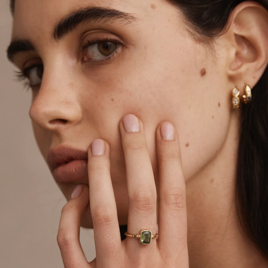 The Romy Apatite Gold Stacker is a real showstopper. It features a gorgeous bezel-set baguette Apatite that catches the light beautifully, with delicate line details on either side. Wear it solo for understated elegance or stack it with other pieces for extra impact.