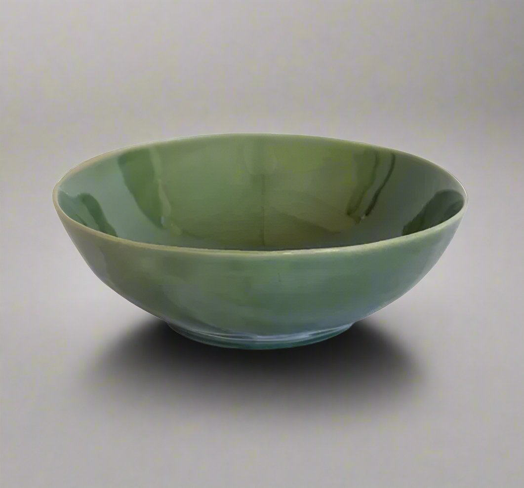 The Glazed Verde & Ivy Salad Bowl boasts a unique, organic shape and texture. The stoneware bowl features a deep green glaze, yielding a timeless aesthetic. Enjoy its distinctive beauty with unique variations in texture and colour. Ideal as a large serving bowl or fruit bowl, this piece exudes organic beauty.