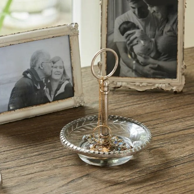 This beautiful Dish carved from brass with a stylish aged silver finish features a graceful cut glass handle. Its ideal size to hold your most meaningful pieces of jewellery and can be placed on your nightstand.