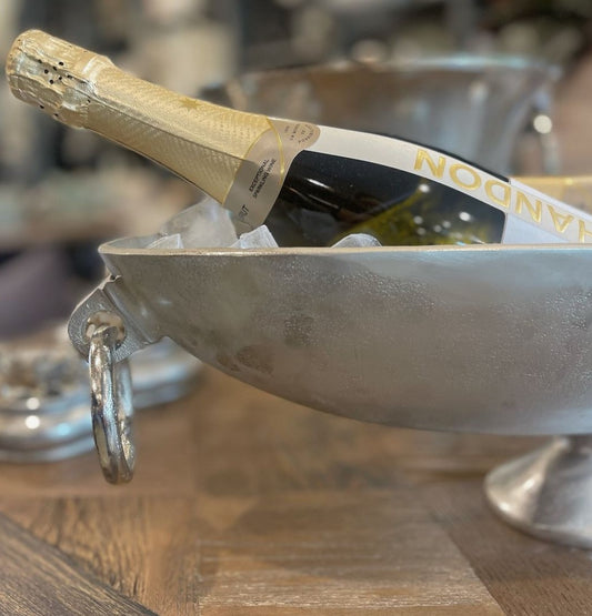 The Gordes Oval Champagne Bowl is cast in solid aluminium with a silver finish. Perfect for adding an elegant touch to your table and special occasions. Styled close up.