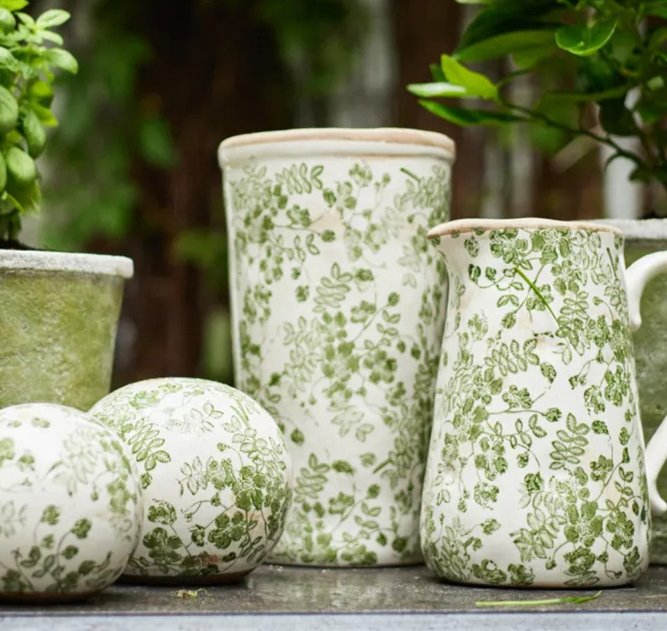 Embrace the rejuvenating essence of nature with the Green Botanical Print Vase. Exquisitely made from stoneware and embellished with a hand-stamped botanical pattern, this adaptable piece infuses a sense of organic charm into any indoor or outdoor area.