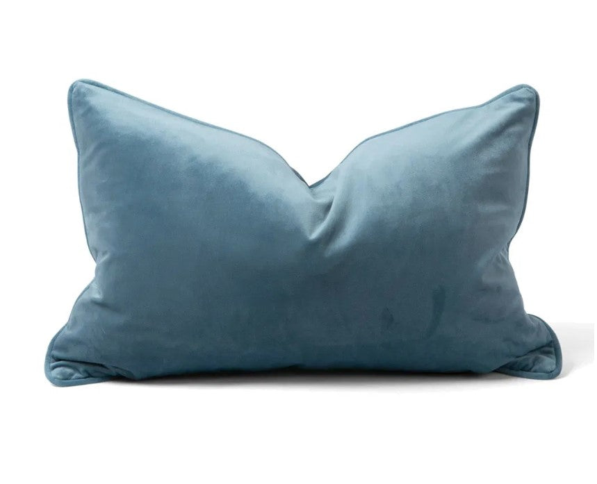 Indulge in the softness of our Blue Velvet Lumbar Cushion. This cushion adds style and luxury to any space, and comes with a concealed zipper for easy use. Filled with feather inserts for ultimate comfort and machine washable on a delicate cycle.