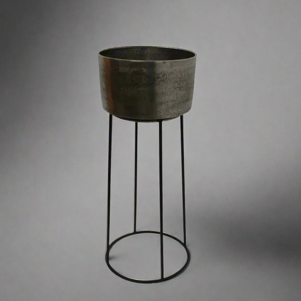 Add a touch of elegance to your gatherings with the Amoy Standing Wine Bucket Large. Its sleek black iron base and antique silver bucket, which can hold up to 4 bottles, make for a convenient and stylish way to serve your favourite wines.