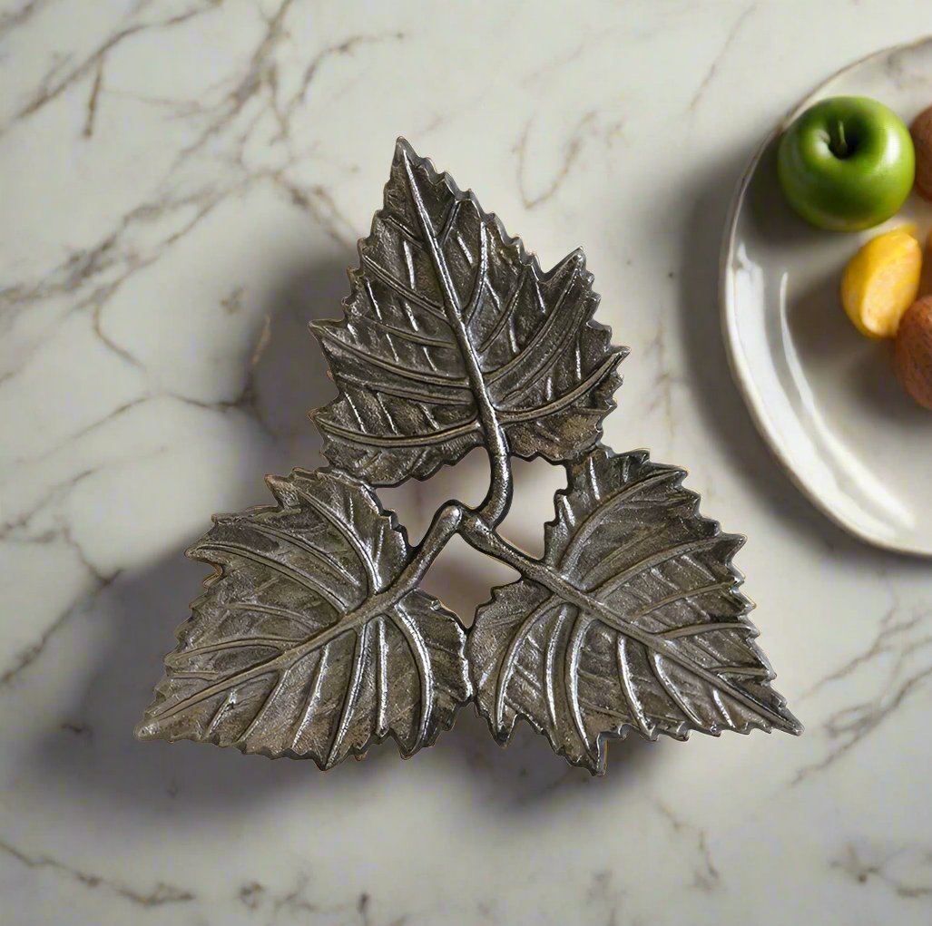 Add warmth and style to your home with the 3 Leaf Trivet in a dark nickel finish. Its unique and elegant 3 leaf design makes it a perfect addition to any table or bench, providing protection against hot dishes. 