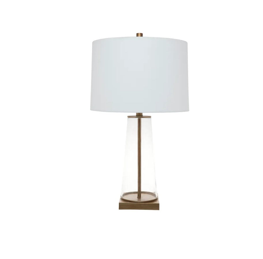 Experience the beauty of skilled craftsmanship with the Tivoli Glass Table Lamp. The clear glass body is accented by a hand-painted antique gold rod and plinth, adding a touch of elegance to any room. The off-white tapered linen shade adds to the delicate aesthetic, making it a truly stunning piece for your home.