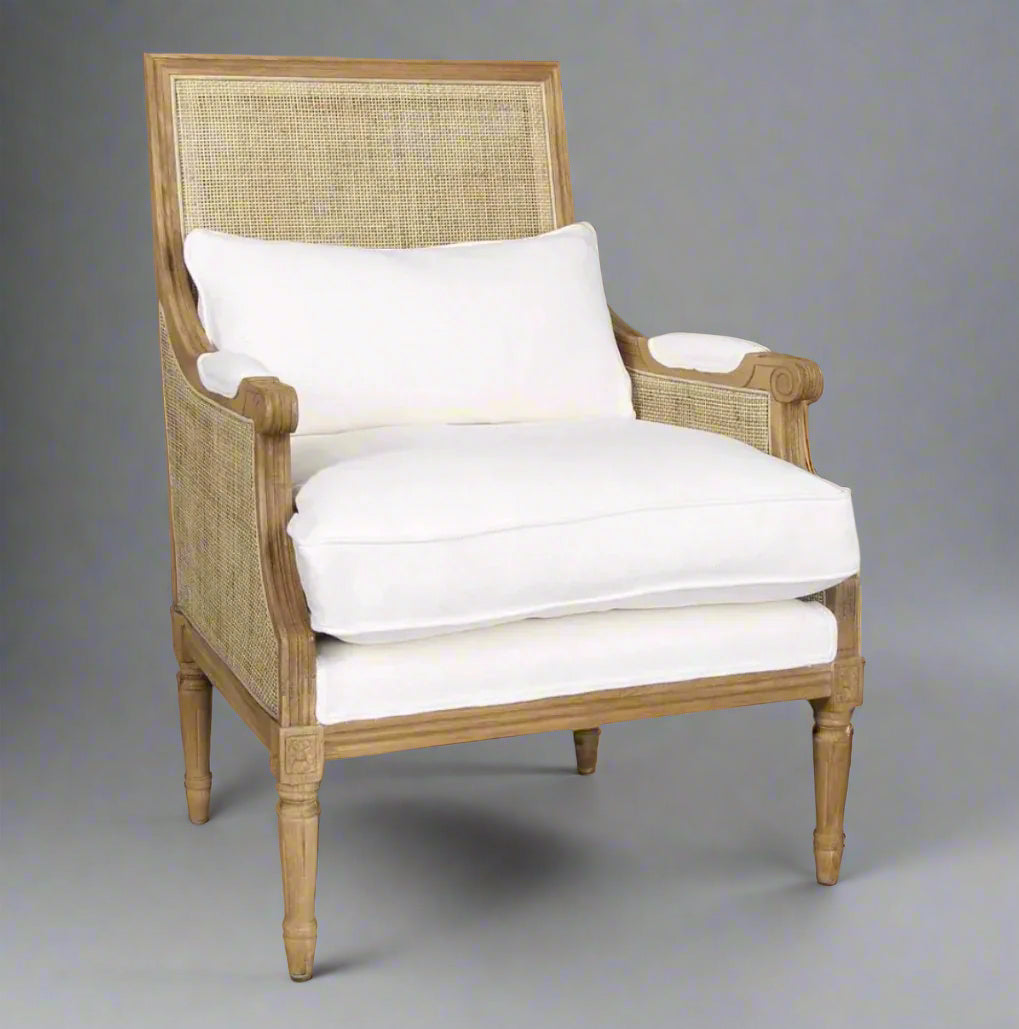 Experience the classic elegance of the Hicks Oak & Rattan Armchair featuring a beautiful carved oak frame, natural rattan back, and soft cotton white upholstery. The plush, removable seat and back cushions make it ideal for any living room or bedroom. Elevate your home decor with this essential piece that offers both style and comfort.