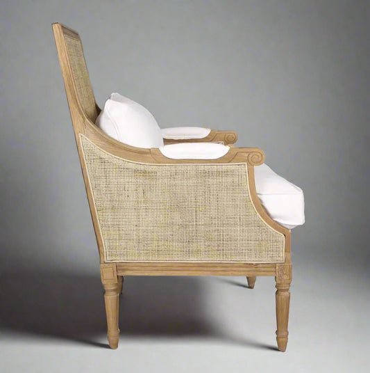 Experience the classic elegance of the Hicks Oak & Rattan Armchair featuring a beautiful carved oak frame, natural rattan back, and soft cotton white upholstery. The plush, removable seat and back cushions make it ideal for any living room or bedroom. Elevate your home decor with this essential piece that offers both style and comfort.