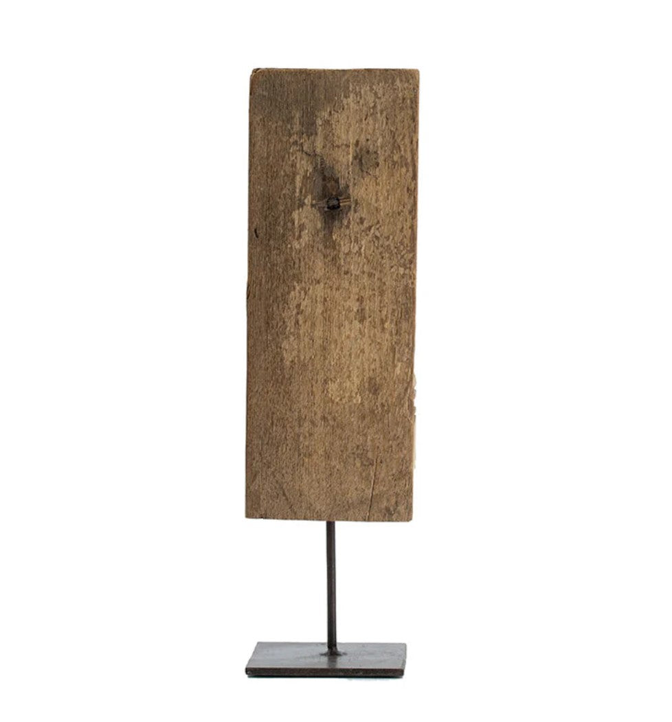 Add a touch of culture to your living room with this stunning Gujrati Toda Wood Sculpture On Metal Stand. Made with distressed wood and featuring intricate carving, it sits on a sturdy metal stand and exudes a rustic charm. Its weathered grey finish and square base give it the appearance of a museum piece, making it a perfect addition to coffee tables, bookshelves, and more.