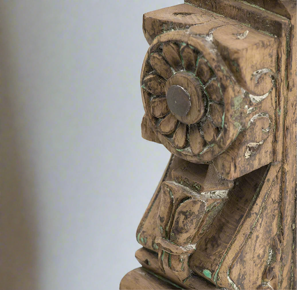Add a touch of culture to your living room with this stunning Gujrati Toda Wood Sculpture On Metal Stand. Made with distressed wood and featuring intricate carving, it sits on a sturdy metal stand and exudes a rustic charm. Its weathered grey finish and square base give it the appearance of a museum piece, making it a perfect addition to coffee tables, bookshelves, and more.