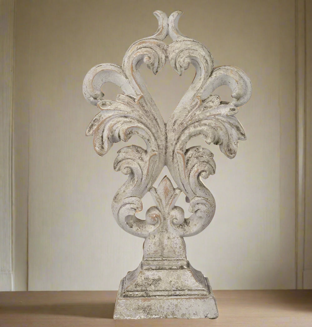 Experience the elegance and sophistication of the Crested Heart Distressed Decorative Object. With its sculptural design and subtle palette, this decorative piece made from cement is finished with a cream distressed effect. Perfect for adding personality to your decor, it will bring a touch of artistic charm to any built-ins or side table vignettes. 