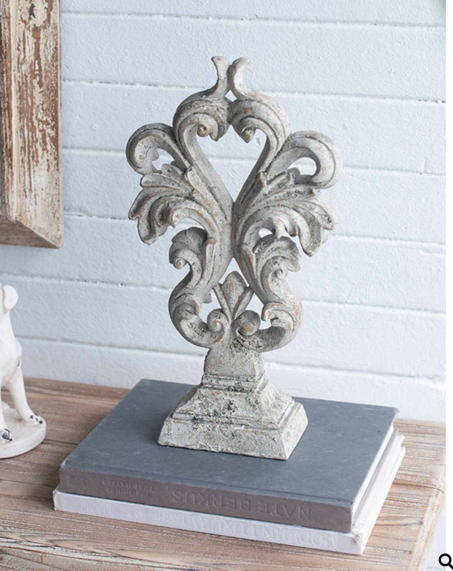 Experience the elegance and sophistication of the Crested Heart Distressed Decorative Object. With its sculptural design and subtle palette, this decorative piece made from cement is finished with a cream distressed effect. Perfect for adding personality to your decor, it will bring a touch of artistic charm to any built-ins or side table vignettes. 