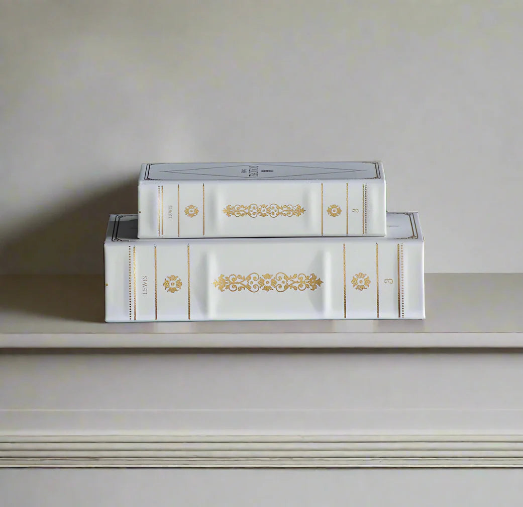 Transform your home decor with our set of 2 Faux French Book Boxes! These luxurious, designer-inspired book boxes add a touch of modern elegance to any space. Use them to decorate your bookshelf, living room, or entryway, creating a stylish and functional look. With their off-white colour and gold detailing, our book boxes are perfect for storing items while also adding a sophisticated touch to your home.