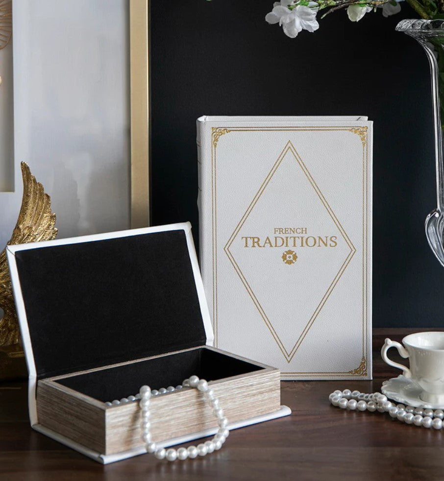 Transform your home decor with our set of 2 Faux French Book Boxes! These luxurious, designer-inspired book boxes add a touch of modern elegance to any space. Use them to decorate your bookshelf, living room, or entryway, creating a stylish and functional look. With their off-white colour and gold detailing, our book boxes are perfect for storing items while also adding a sophisticated touch to your home.