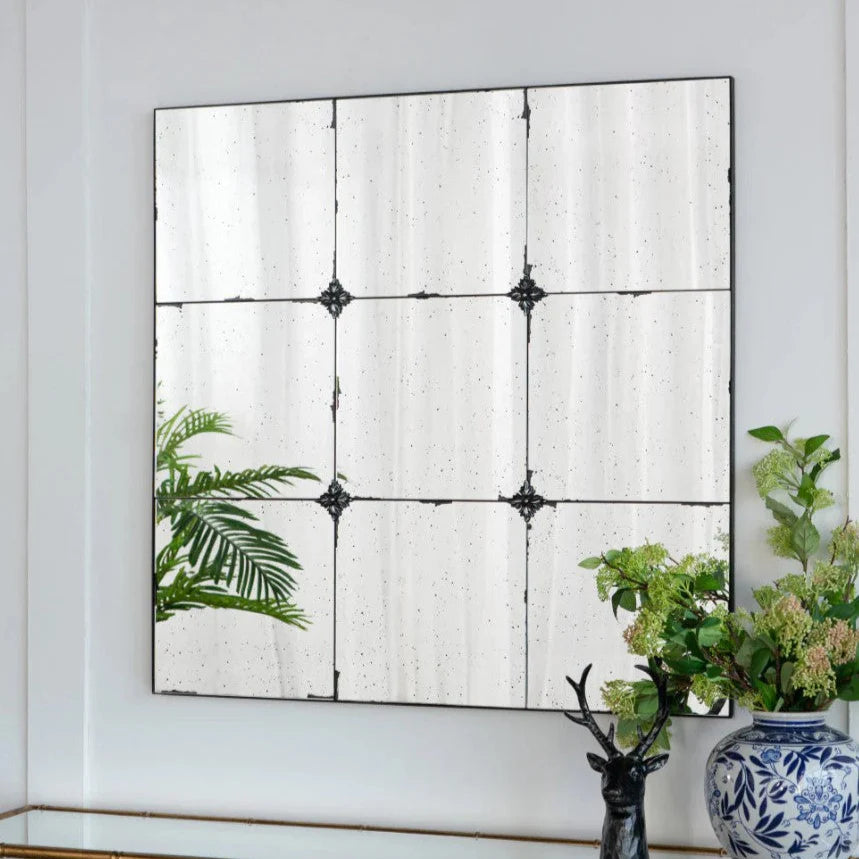 Discover the rustic and romantic charm of the Odette Antique Glass Panel Square Mirror. Featuring heavily antiqued glass panels and resin flower pattern hardware, this mirror exudes vintage elegance. Each panel has a unique hue, creating a composition that is both subtle and mesmerising.