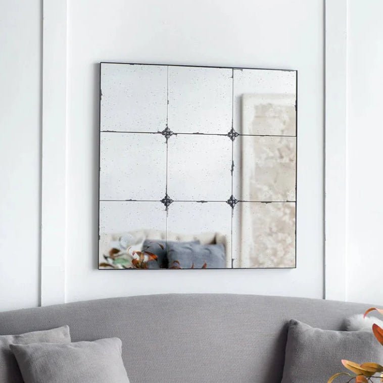 Discover the rustic and romantic charm of the Odette Antique Glass Panel Square Mirror. Featuring heavily antiqued glass panels and resin flower pattern hardware, this mirror exudes vintage elegance. Each panel has a unique hue, creating a composition that is both subtle and mesmerising.