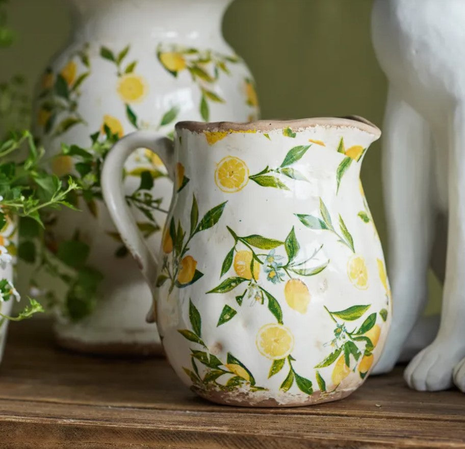 Create a Mediterranean atmosphere in any environment with theSicily Lemon Botanical Stoneware Jug. Handcrafted from durable stoneware and intricately adorned with a delightful lemon pattern, this jug adds a unique and inviting element to indoor and outdoor spaces alike.