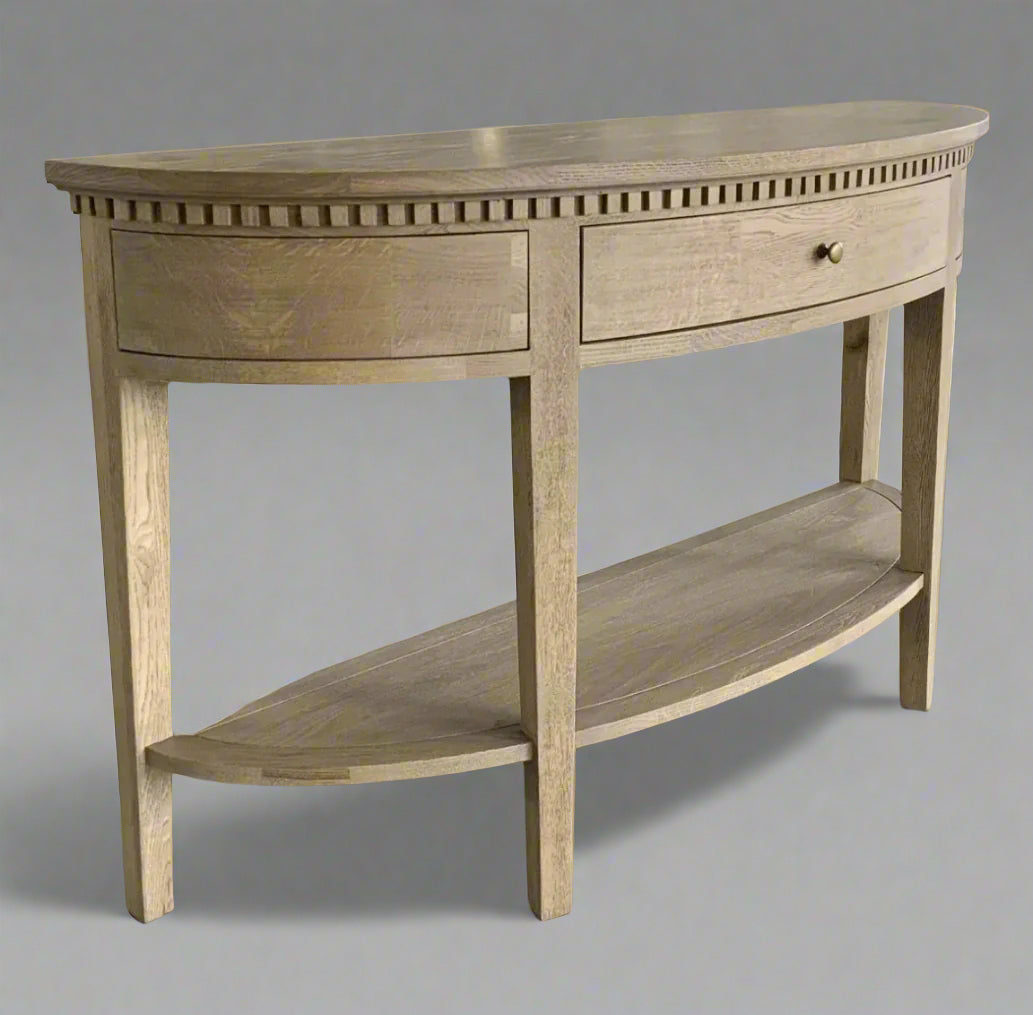 Experience the timeless beauty of the Claude Weathered Oak Curved Console Table. Crafted from solid oak and oak veneer in a stunning weathered oak finish, this table is perfect for any hallway, living room, or bedroom. It features a single dovetailed drawer with a sleek brass handle, adding both functionality and a touch of elegance.