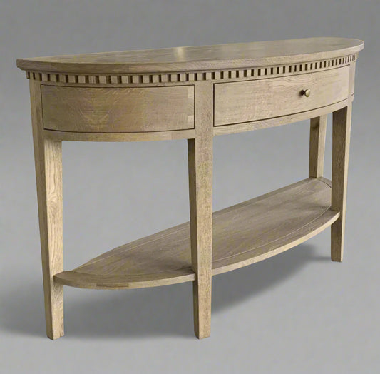Experience the timeless beauty of the Claude Weathered Oak Curved Console Table. Crafted from solid oak and oak veneer in a stunning weathered oak finish, this table is perfect for any hallway, living room, or bedroom. It features a single dovetailed drawer with a sleek brass handle, adding both functionality and a touch of elegance.
