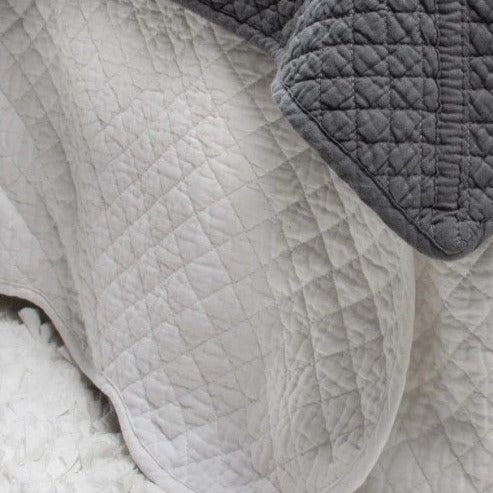 Indulge in the timeless elegance of the Lyon Valance, perfect for enhancing any bedding ensemble. The classic grid stitch design adds versatility and charm, effortlessly blending with any style. This queen size quilted bed skirt is crafted from 100% cotton with wadding for comfort and durability. Best of all, it's easily machine washable on a delicate cycle.