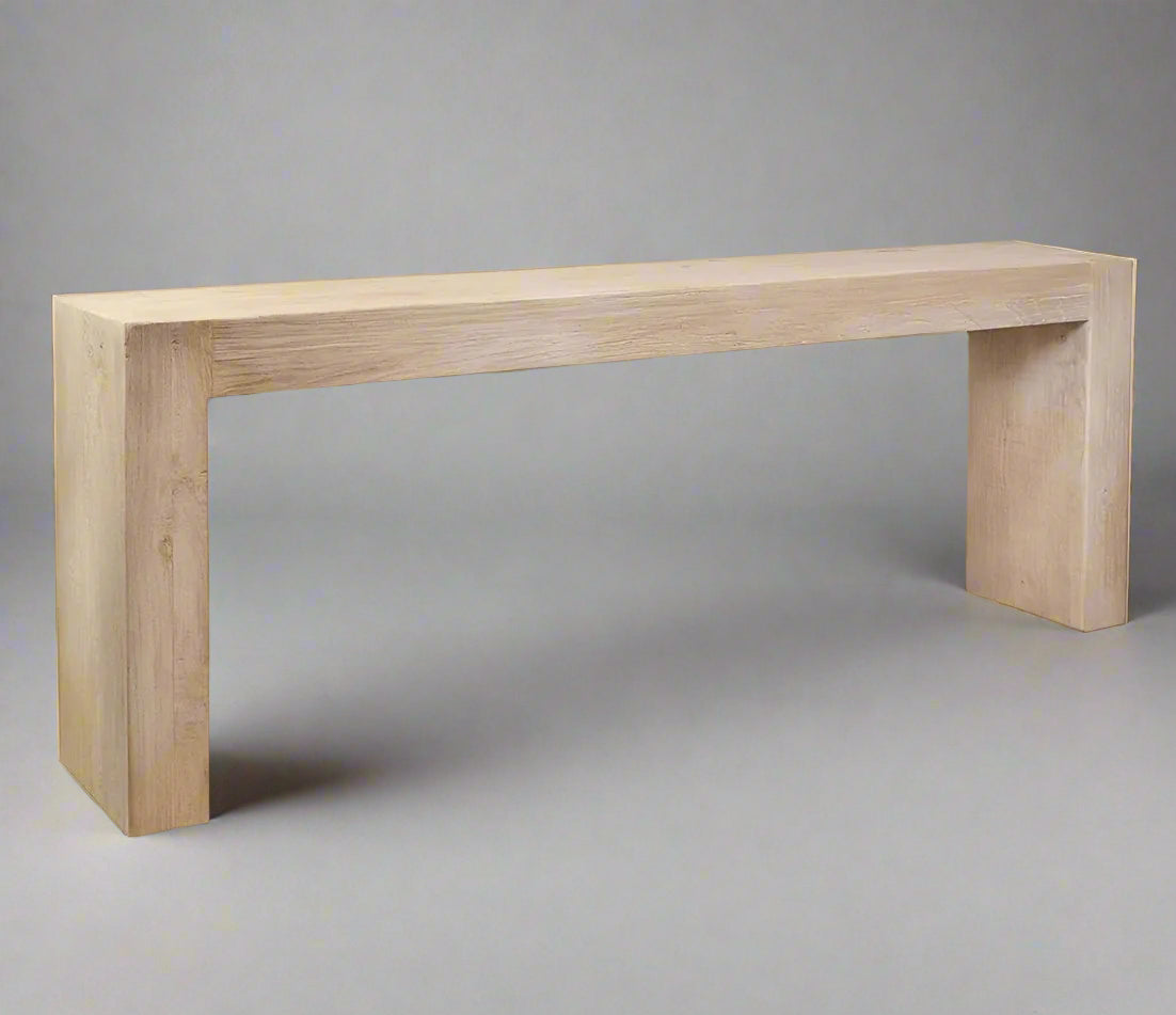 The Reclaimed Elm Timber Console 200cm is a beautiful piece of furniture skilfully handcrafted from reclaimed elm. With a rustic finish, it exudes a timeless charm that combines nature's elegance with artistic craftsmanship. This outstanding console showcases a harmonious blend of organic textures and geometric precision, highlighting the unique grains and weathered history of the reclaimed wood. Perfect for any space, it can be placed behind a sofa or in a hallway, providing both functional utility and a s