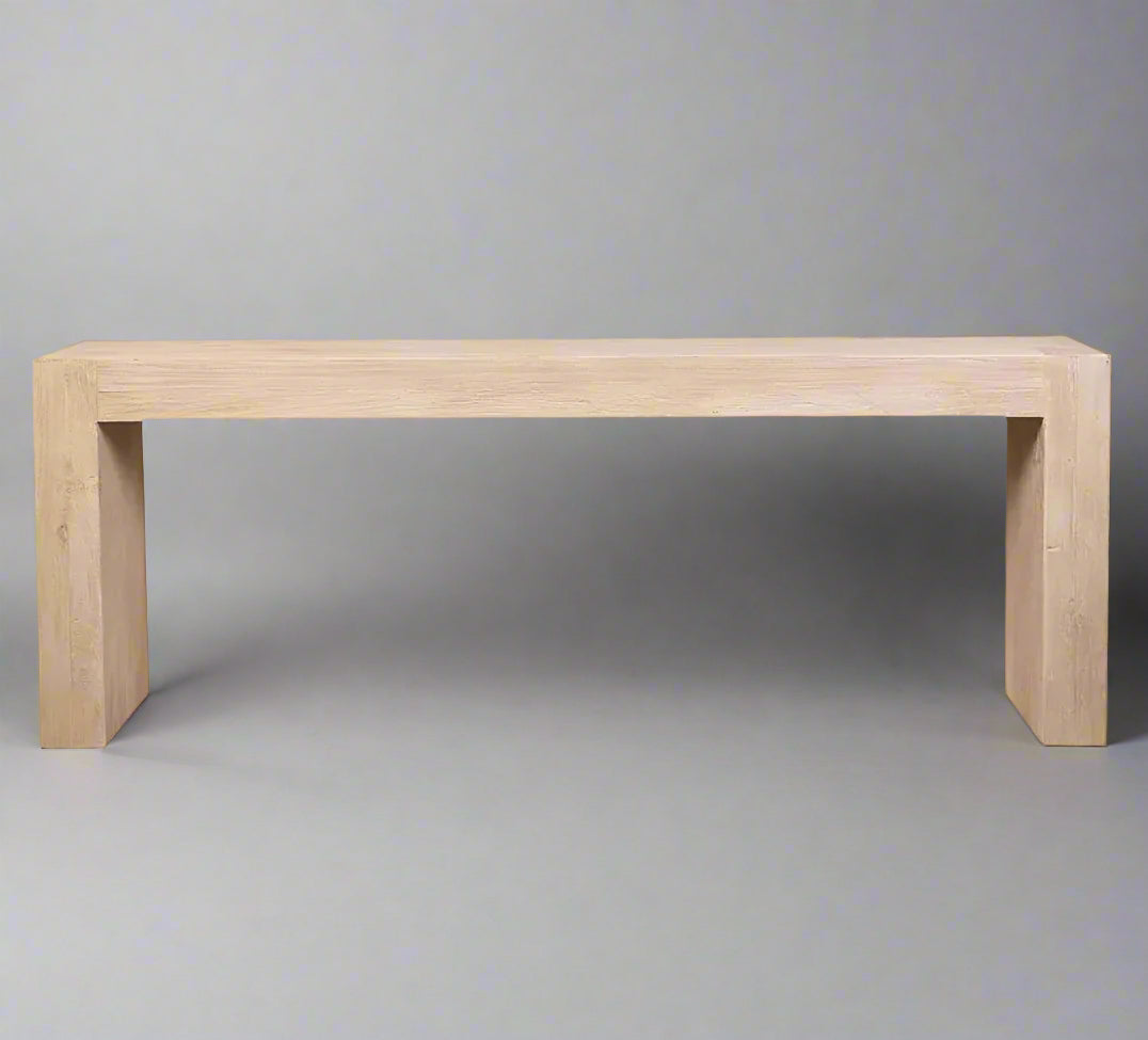 The Reclaimed Elm Timber Console 200cm is a beautiful piece of furniture skilfully handcrafted from reclaimed elm. With a rustic finish, it exudes a timeless charm that combines nature's elegance with artistic craftsmanship. This outstanding console showcases a harmonious blend of organic textures and geometric precision, highlighting the unique grains and weathered history of the reclaimed wood. Perfect for any space, it can be placed behind a sofa or in a hallway, providing both functional utility and a s