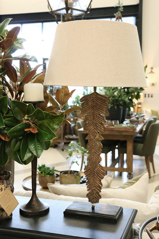 Experience the striking beauty of the Palma Lamp in any room of your home. Crafted from durable iron with a stunning palm bronze finish, this lamp is a true statement piece. The gorgeous Flax Basket Weave Drum shade perfectly complements the design, creating a captivating atmosphere in any space. Lamp requires a B22 bayonet bulb.