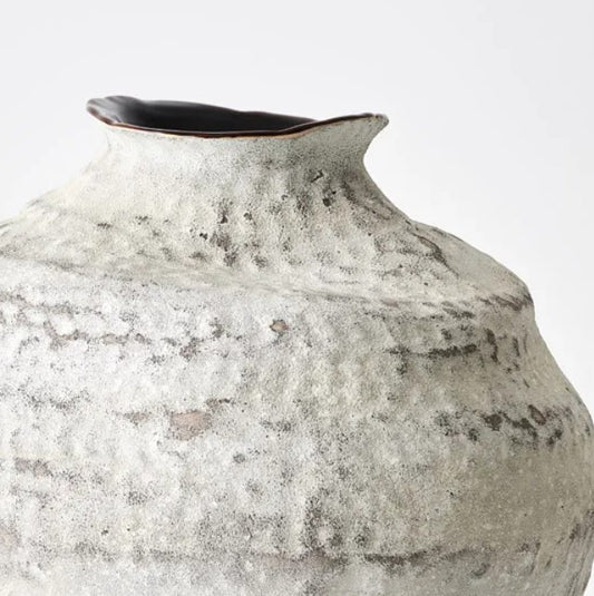 The Capri White & Tan Rustic Vase boasts a timeless traditional shape. Its stunning White and Tan colour scheme make it a standout piece. This versatile vase adds organic texture and a classic silhouette to any space, elevating it with artisan quality and charm.