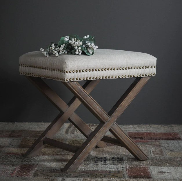 The Winston Ottoman provides a timeless design featuring an upholstery of natural-colored linen and brass studs, set upon white-washed ash wood legs. Perfect for the foot of a bed or near a side table, the light palette of the fabric and timber wash easily complements any room. Front