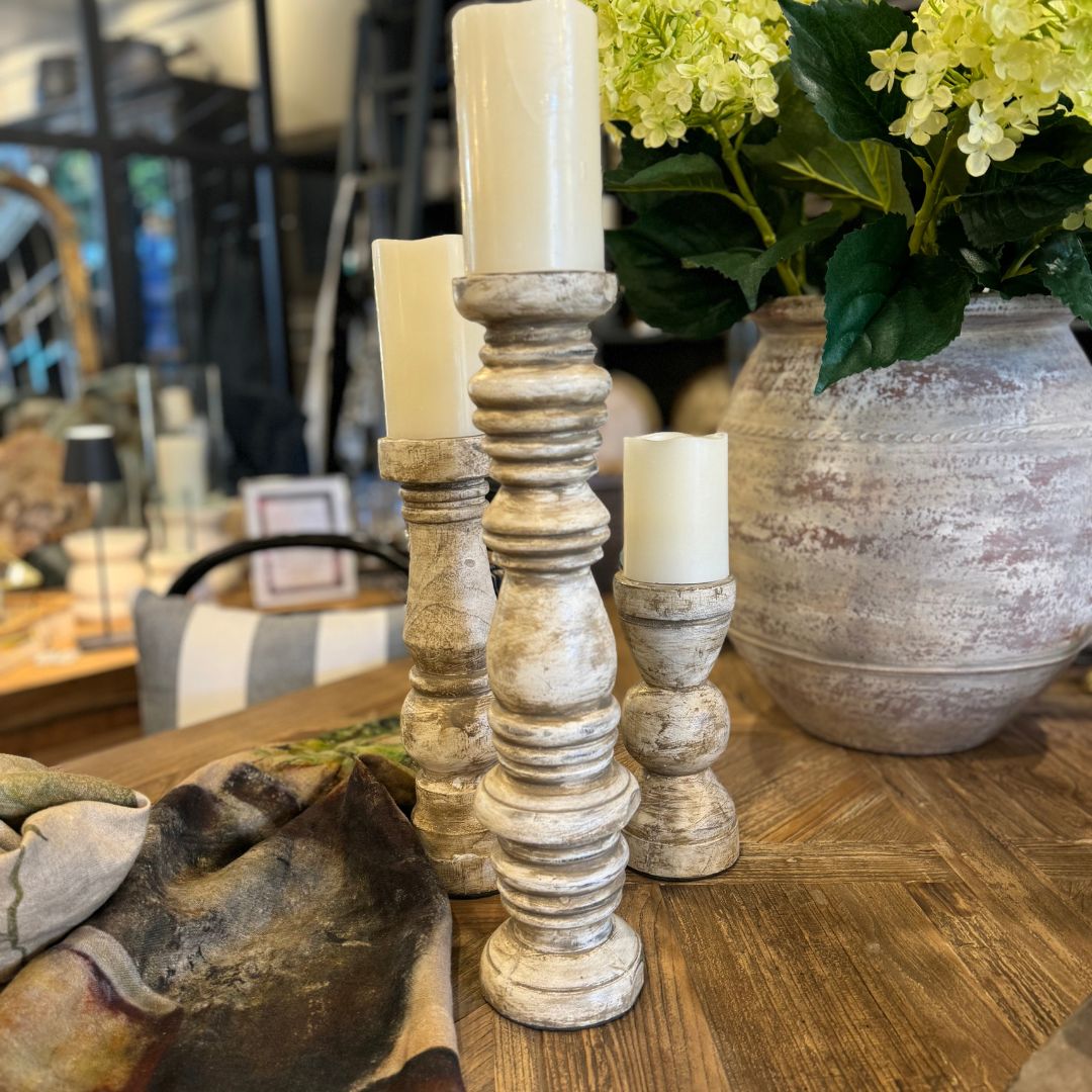 We love the chunky yet elegant Gordes Cream Distressed Teak Candle Holder. Their soft curves and shapes accentuate the beauty of the natural recycled teak that have been gently distressed for vintage appeal. They are substantial enough to work on their own or as a beautiful collection of candle holders on a mantelpiece or a table.