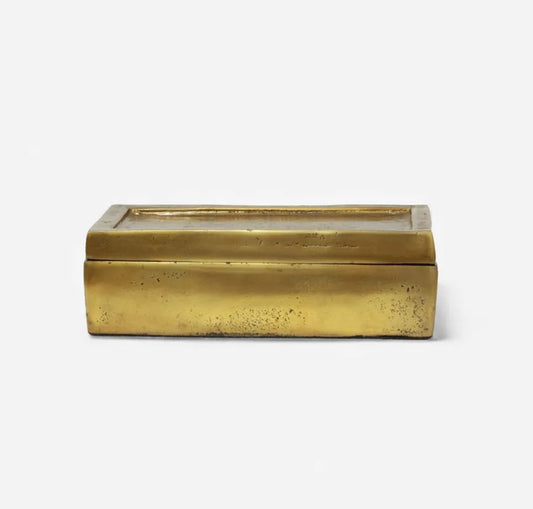 Rectangular brass box with a glass lid on a white background