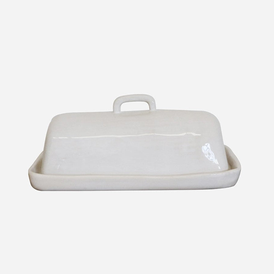 The Creamery Handcrafted Butter Dish has a unique organic shape, texture and colour, adding to the item's distinct beauty. The dish is composed of stoneware and boasts a soft ivory cream glaze, combining to create a timeless look. These pieces are designed to offer everyday convenience as they are dishwasher, microwave, and oven safe.