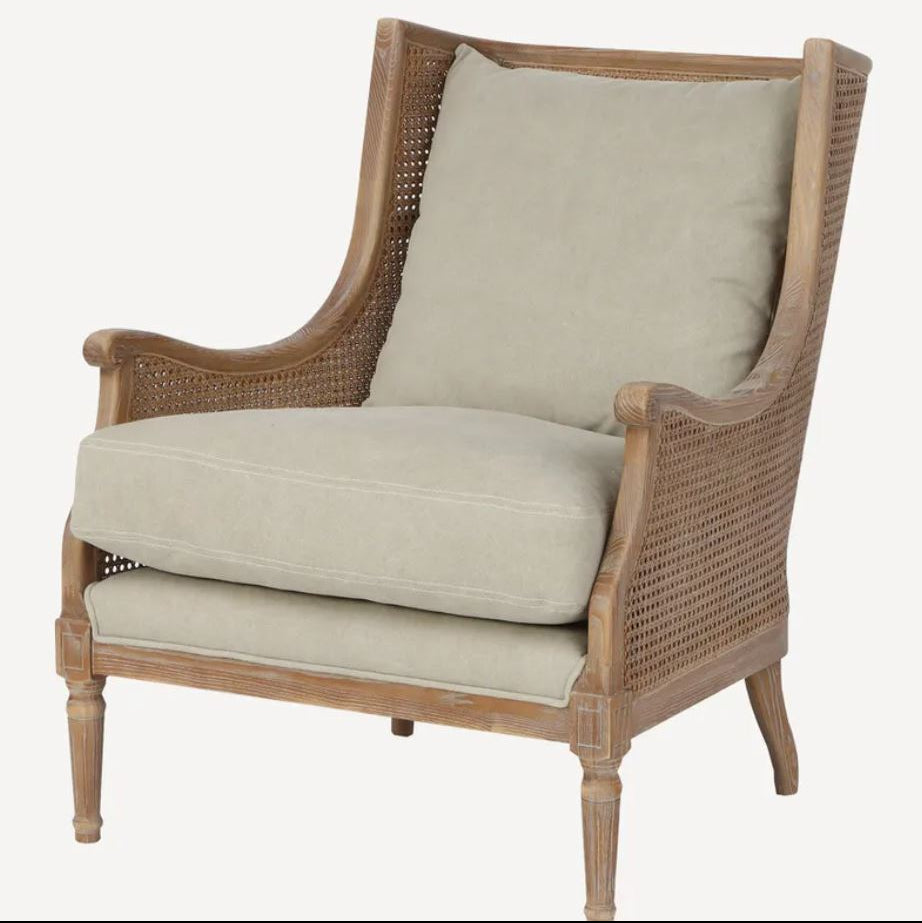 Wicker armchair with beige cushions on a white background