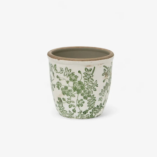 Ceramic pot with green floral pattern on a white background