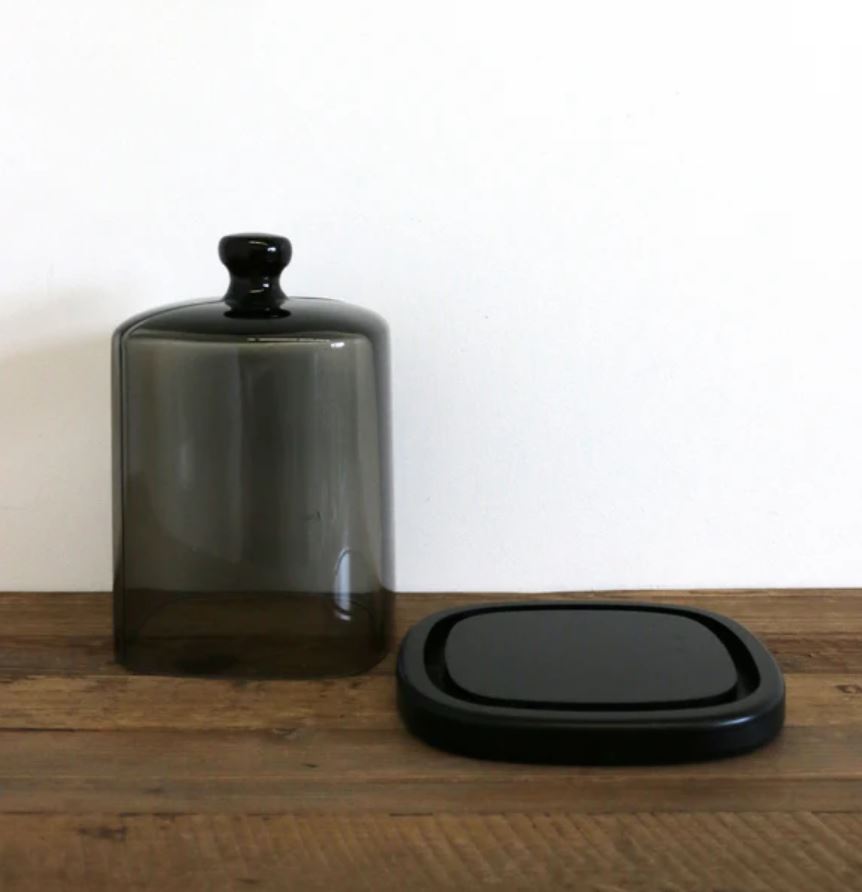 Perfect for displaying luxury candles, this smoke glass dome with black base protects fragrance while adding understated, stylish elegance to your home.