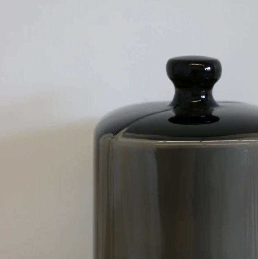 Perfect for displaying luxury candles, this smoke glass dome with black base protects fragrance while adding understated, stylish elegance to your home.
