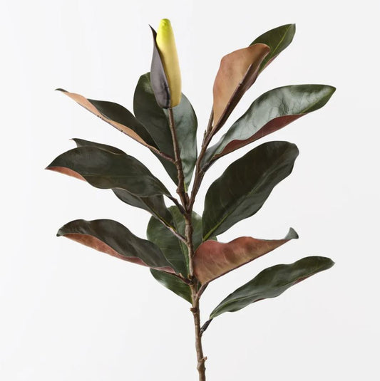 Artificial plant branch with green and brown leaves on a white background