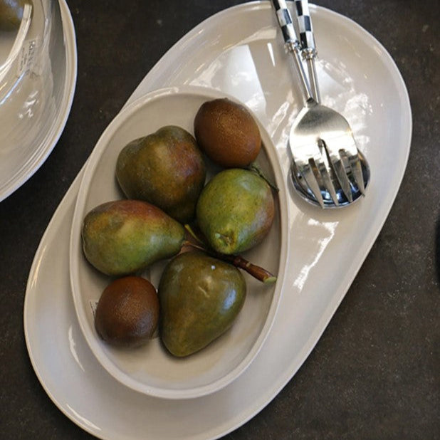 The Creamery Handcrafted Oval Platter has a unique organic shape, texture and colour, adding to the item's distinct beauty. The platter is composed of stoneware and boasts a soft ivory cream glaze, combining to create a timeless look. These pieces are designed to offer everyday convenience as they are dishwasher, microwave, and oven safe.