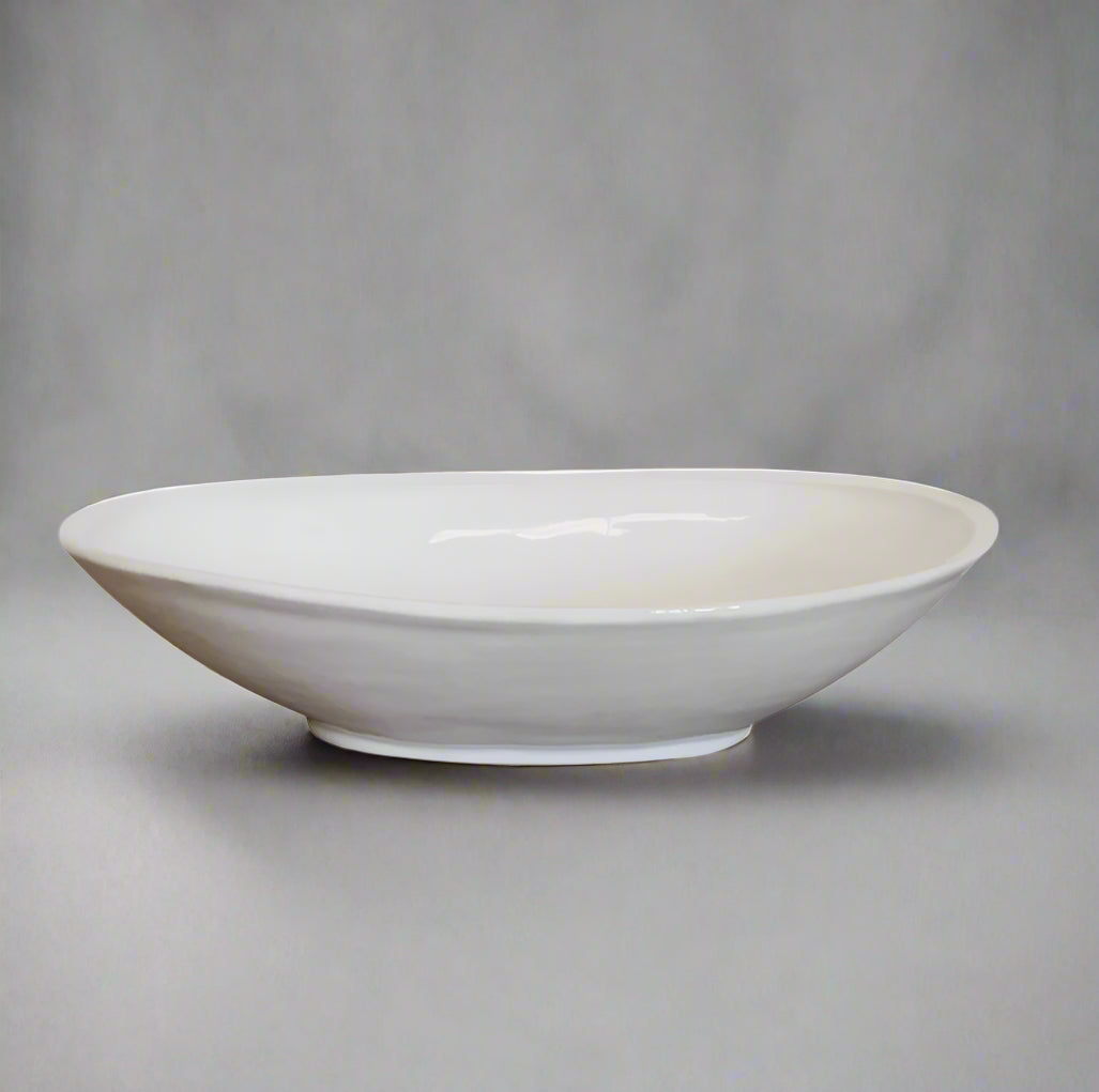The Creamery Handcrafted Oval Serving Dish has a unique organic shape, texture and colour, adding to the item's distinct beauty. The dish is composed of stoneware and boasts a soft ivory cream glaze, combining to create a timeless look. These pieces are designed to offer everyday convenience as they are dishwasher, microwave, and oven safe.