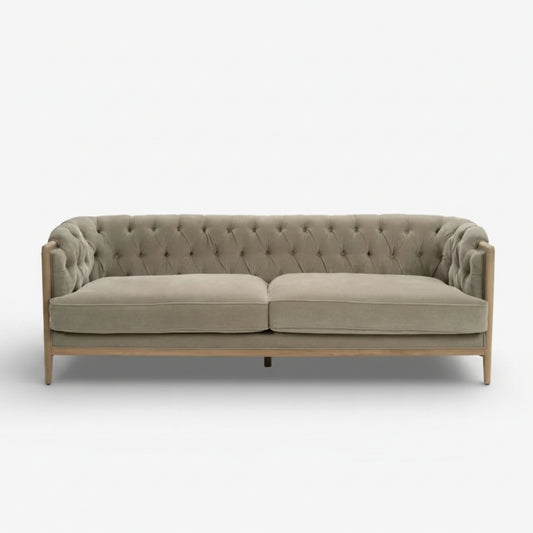 Gray tufted sofa on a white background