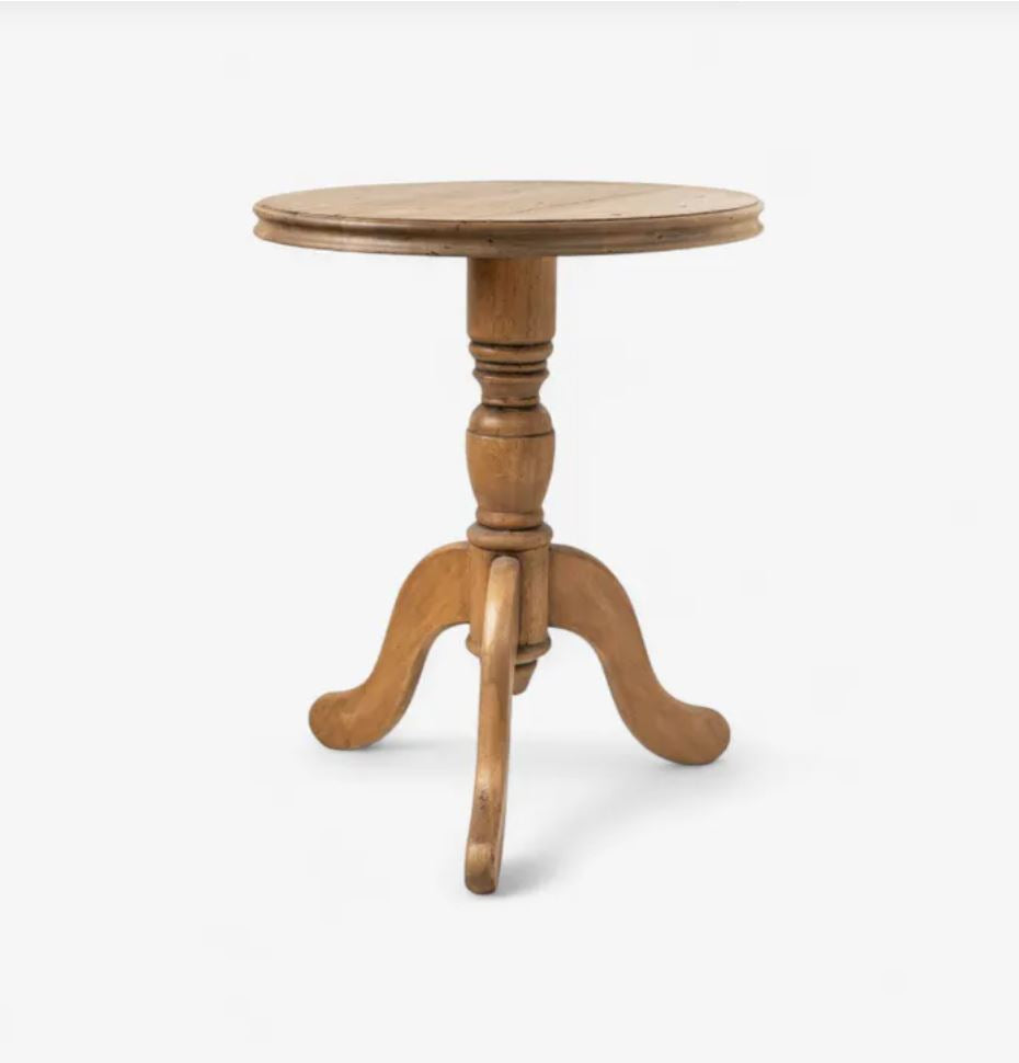 Wooden round table with a pedestal base on a white background
