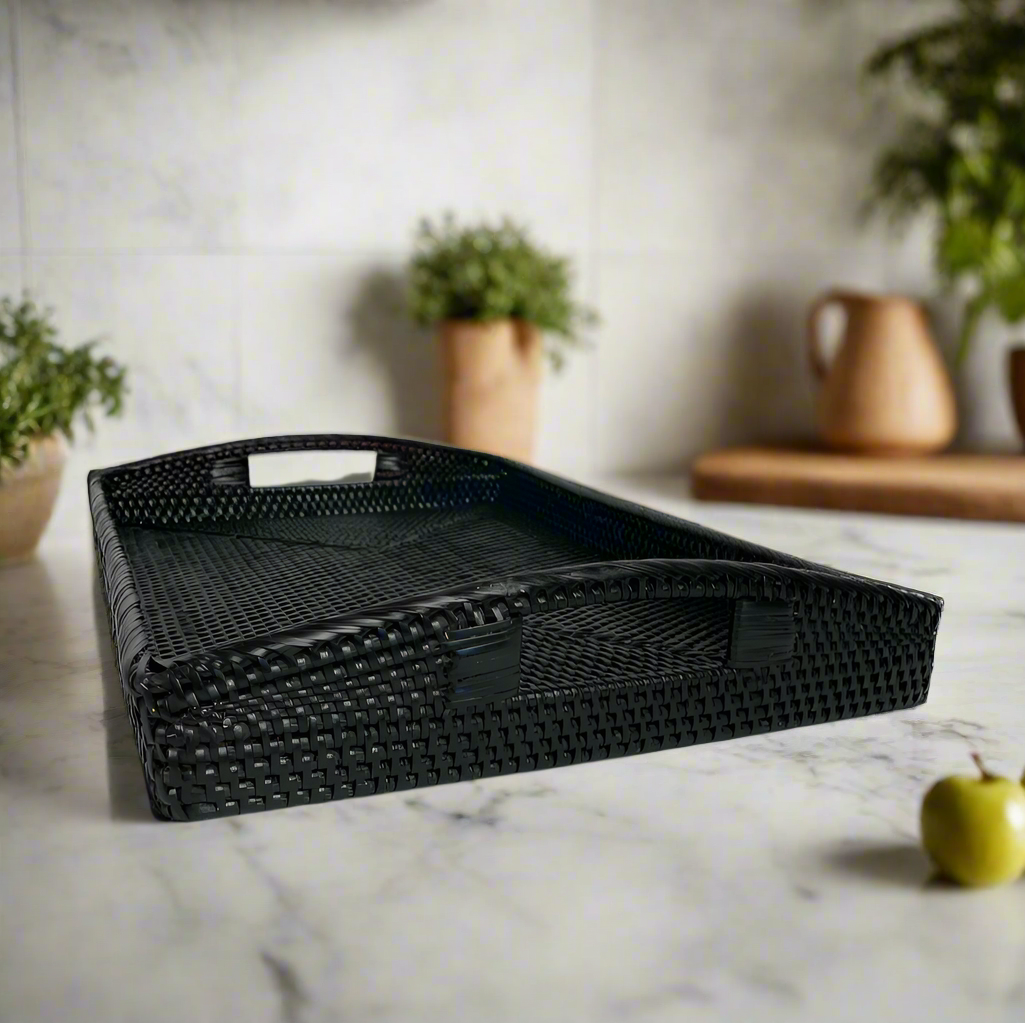 Elevate your beverage service with our Baki Rattan trays. Featuring a sleek rectangular design and convenient cut-out handles, these trays are perfect for serving coffee or cocktails in style. Made from rattan, they are both functional and stylish. Front